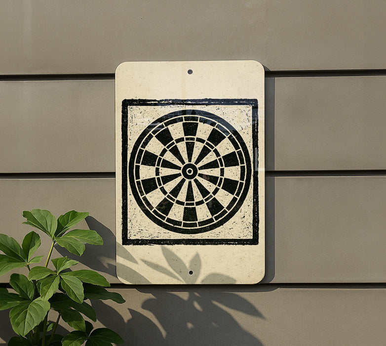 a white sign with a black and white dartboard design on it, mounted on a wall.