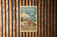 A vintage-style poster of a boardwalk and beach promenade in Delaware, featuring a couple walking along the boardwalk and a scenic view of the ocean and buildings in the background.