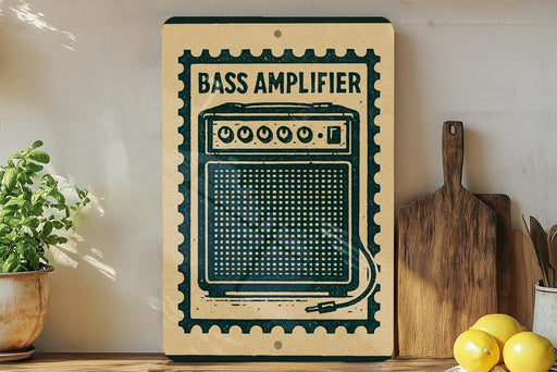 a vintage-style sign with a bass amplifier design, placed on a wooden surface next to a potted plant and a wooden cutting board.