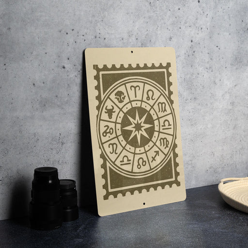 a wooden sign with a zodiac wheel design on it, placed on a table next to some black camera lenses.