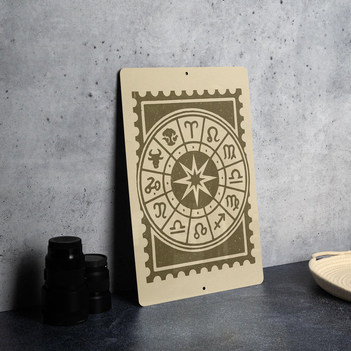a wooden sign with a zodiac wheel design on it, placed on a table next to some black camera lenses.