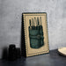 a framed illustration of a knife set, with a green leather case containing multiple knives.