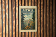 A vintage-style poster of the High Country overlooks, featuring a scenic landscape with mountains, pine trees, and two people standing on a rock.