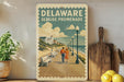 A vintage-style poster of a boardwalk in Delaware, featuring a couple walking along the boardwalk with a scenic view of the ocean and buildings in the background.