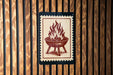 a sign with a red and white design depicting a fire pit or grill.