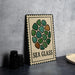 a decorative sign with a sea glass design, placed on a table next to some black camera lenses.