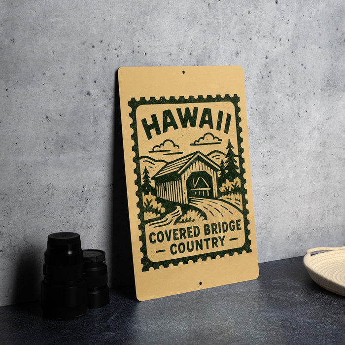 A sign for the Covered Bridge Country in Hawaii, featuring a wooden bridge and mountains in the background.