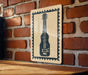 A wooden table with a brick wall in the background, and a framed image of a guitar on the wall.