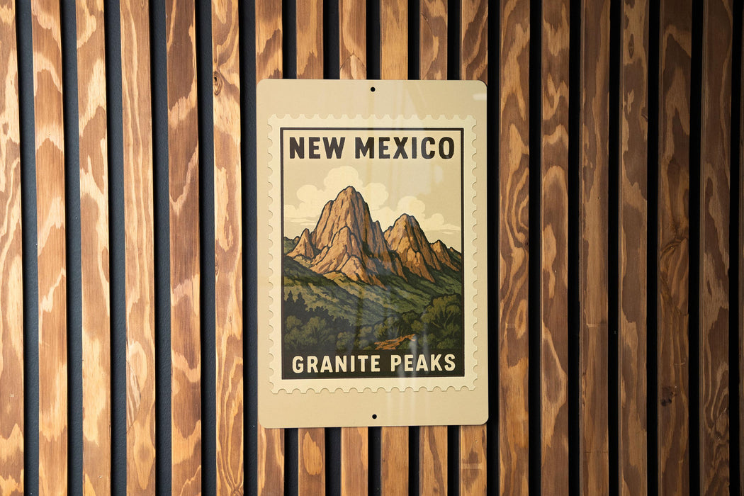 A sign for New Mexico's Granite Peaks is displayed on a wooden wall.