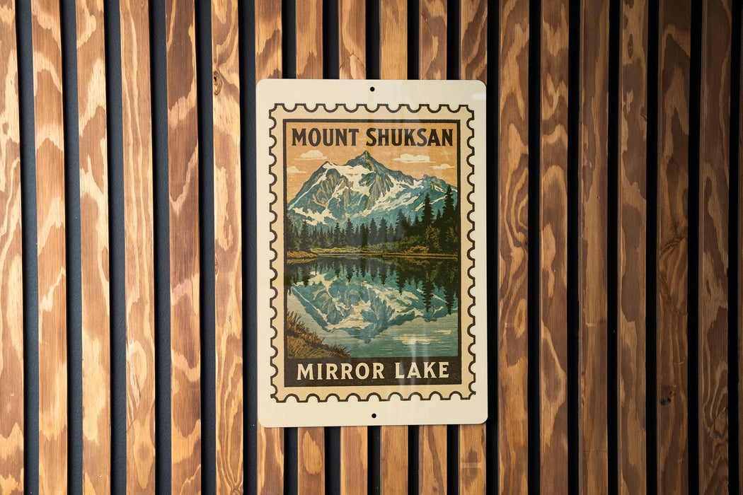 A framed image of a mountain lake, with the text "MOUNT SHUKSAN" and "MIROR LAKE" printed on it, is displayed on a wooden wall.