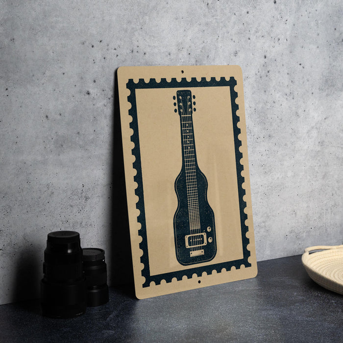 a framed print of a guitar on a wall, with a stack of black camera lenses and a woven basket placed next to it.