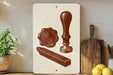 a white sign with a red illustration of a seal, a wax seal, and a wooden cutting board, placed on a wooden shelf next to a potted plant and some lemons.