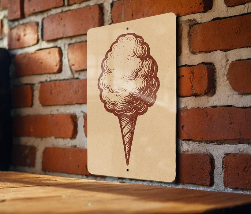 a sign with a drawing of a cotton candy cone on it, mounted on a brick wall.