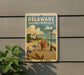 A vintage-style sign for Delaware's Seaside promenade, featuring a couple walking along a boardwalk with benches and a scenic view of the beach and ocean.