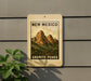 A sign for New Mexico's Granite Peaks, featuring a mountain landscape illustration.