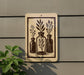 a sign with a black and white illustration of three vases with plants, mounted on a wall.