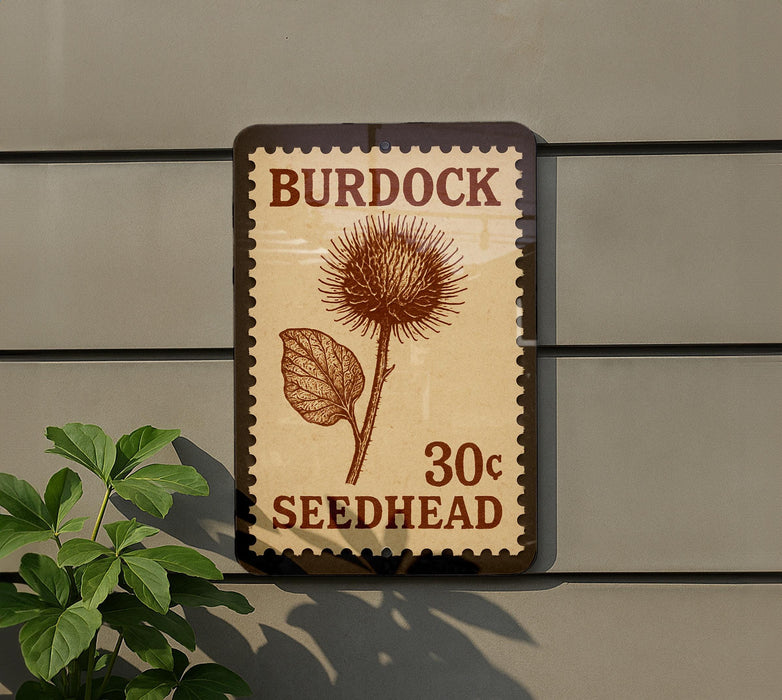 A postage stamp-like sign with the text "Burdock 30c Seedhead" and an illustration of a thistle flower.