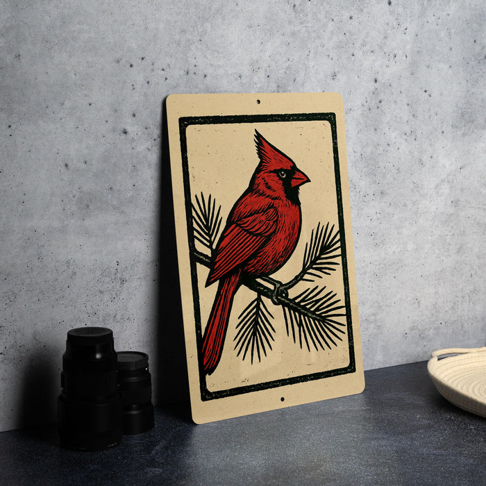 a red cardinal perched on a branch, with a beige background and a black border.
