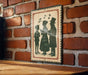 A vintage-style metal sign with silhouettes of three people, likely depicting a group of people singing, is mounted on a brick wall.
