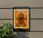 A gingerbread man figure is displayed on a wall, framed by a decorative border.