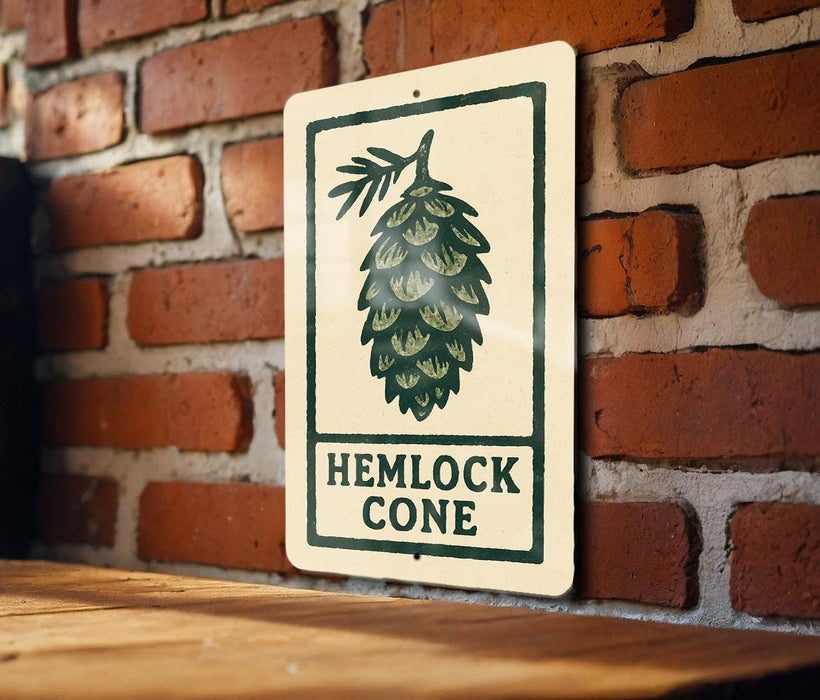 A sign with the text "HEMLOCK CONE" is displayed on a brick wall, with a wooden table below it.