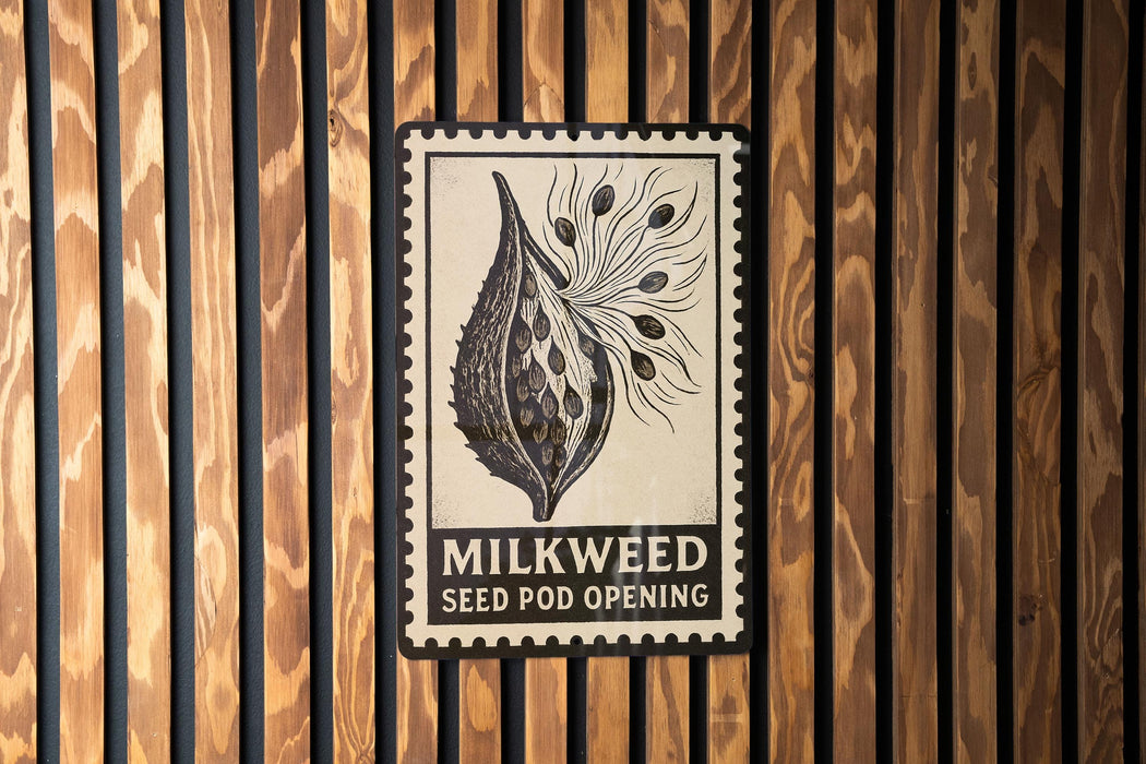 a seed pod opening sign with the text "MILKWEED SEED POD OPENING" displayed prominently.