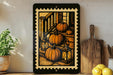 a framed illustration of pumpkins on a porch, with a wooden rocking chair and lanterns nearby.