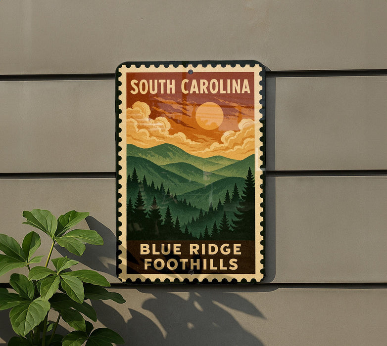 A metal sign with a vintage-style illustration of a mountain landscape, featuring a sun and clouds, mounted on a wall.