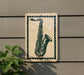 A sign featuring a saxophone is mounted on a wall, with a plant visible to the left.