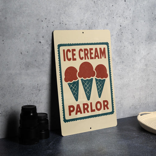 A sign for an ice cream parlor, featuring the text "ICE CREAM PARLOR" and three ice cream cones.