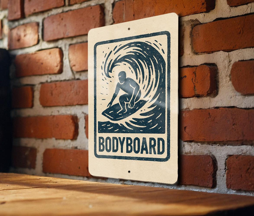 A sign with a surfboard graphic and the word "BODYBOARD" is displayed on a brick wall.