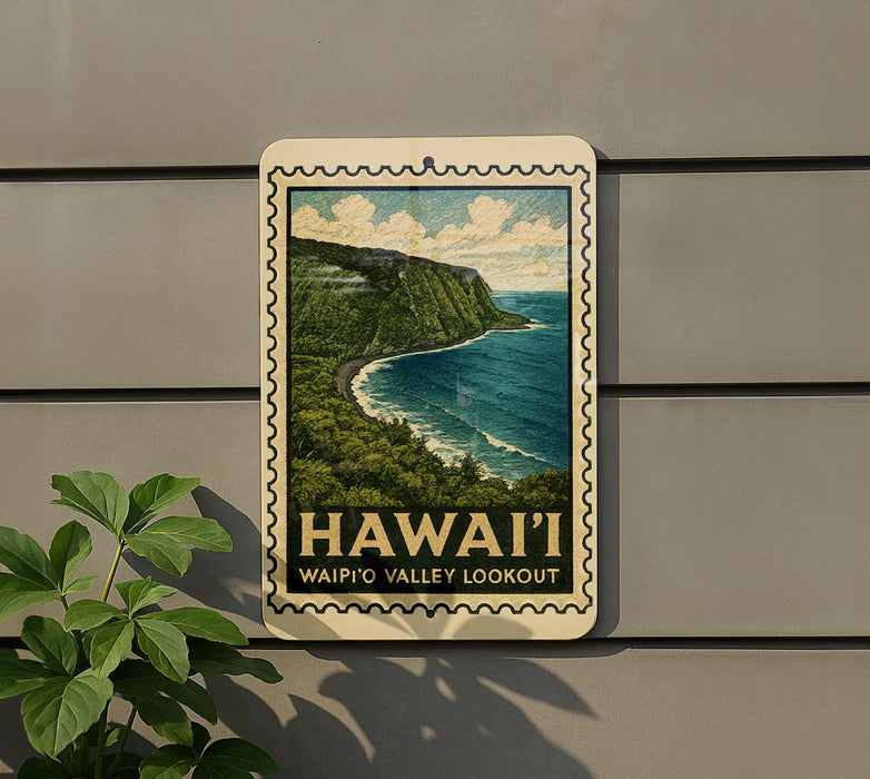 A framed poster of a scenic coastal landscape with the text "HAWAII'I WAIP'O VALLEY LOOKOUT" displayed on a wall.