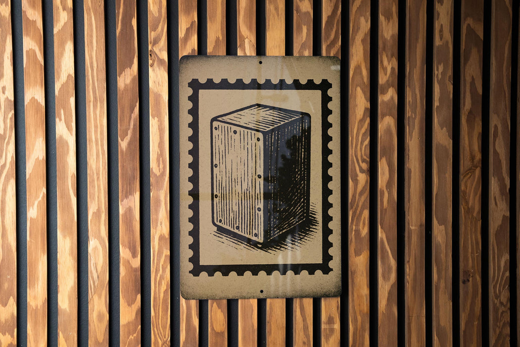 a wooden wall with a framed illustration of a rectangular object, which appears to be a musical instrument or a box.