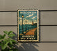 A vintage-style metal sign with a lighthouse and a wooden walkway, mounted on a wall.