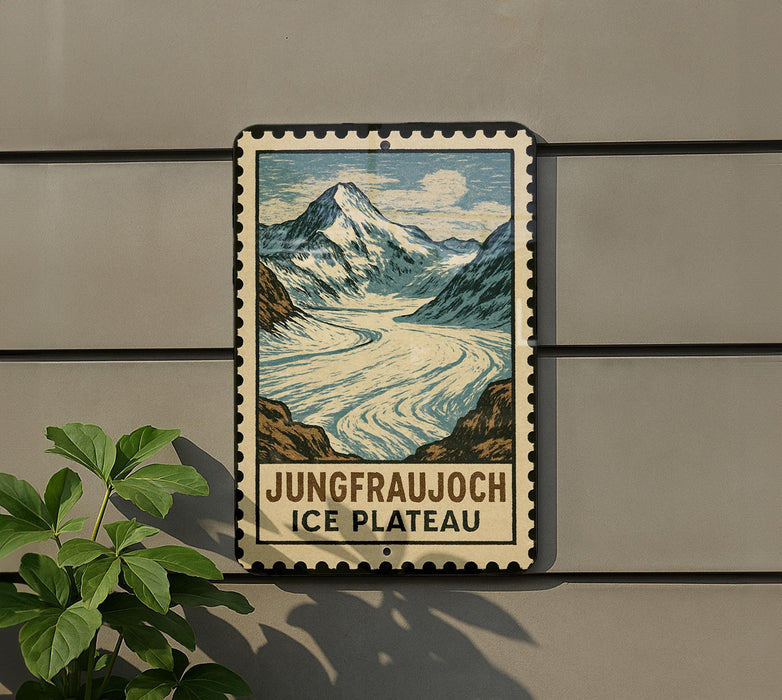 A vintage-style metal sign with a mountain landscape and a river, mounted on a wall.