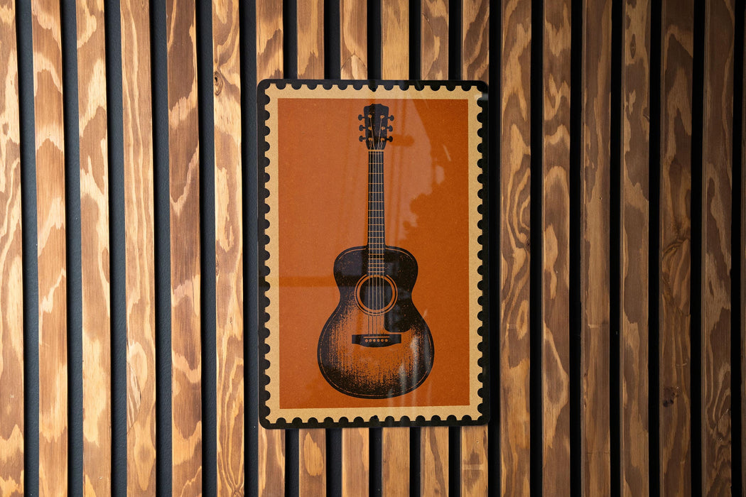 a guitar poster displayed on a wooden wall.