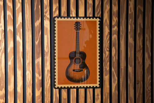 a guitar poster displayed on a wooden wall.