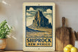A framed illustration of a mountain landscape with the text "SHIPROCK NEW MEXICO" is displayed on a shelf, accompanied by a wooden cutting board and a potted plant.