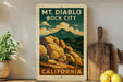 A vintage-style poster of Mount Diablo, a famous landmark in California, is displayed on a wall next to a wooden cutting board and some potted plants.