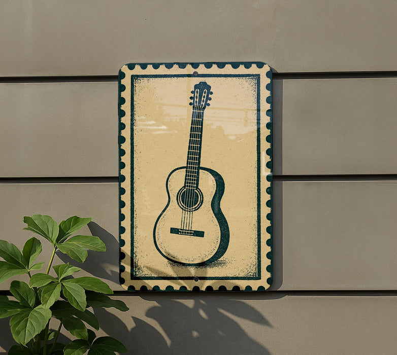 a guitar sign on a wall, with a plant to the left of the sign.