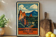 A vintage-style metal sign with a mountain landscape and clouds, featuring the text "GARDEN OF THE GODS OVERLOOK CO" on it. The sign is displayed on a shelf next to a potted plant, a cutting board, and some lemons.