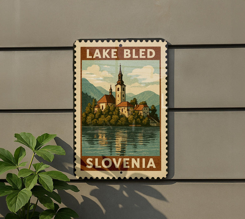 A vintage-style sign depicting Lake Bled, Slovenia, with a church and mountains in the background.
