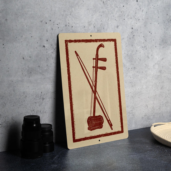 a sign with a red and beige design, depicting a musical instrument, such as a violin or cello, with crossed bows.