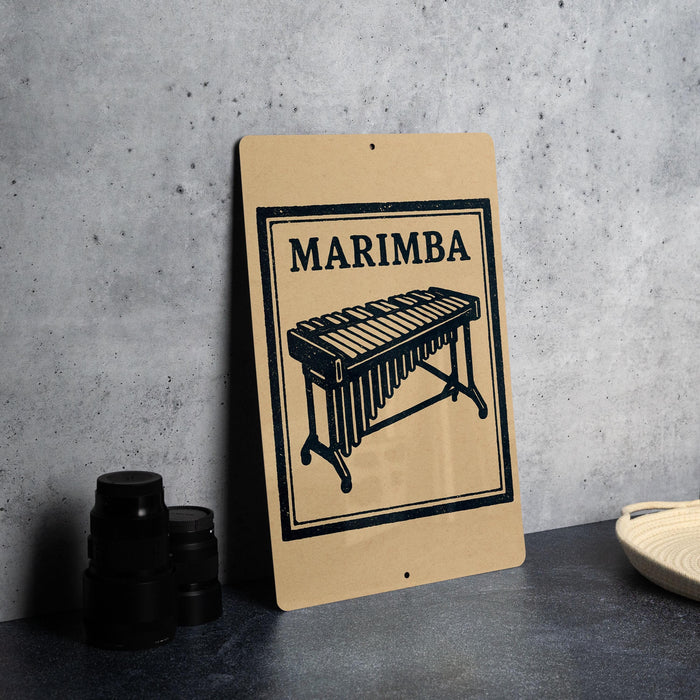 a sign with the word "MARIMBA" and an illustration of a musical instrument, likely a marimba, placed on a table.