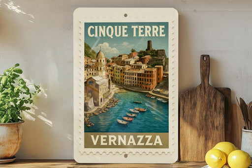 A framed poster of the town of Vernazza, Italy, featuring a scenic view of the town and its harbor.