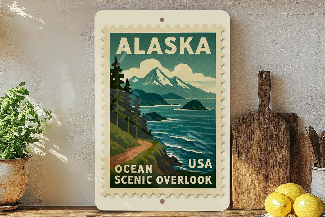A vintage-style postage stamp depicting a scenic overlook in Alaska, USA, with mountains, trees, and a body of water.