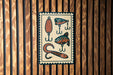 A sign featuring illustrations of fishing lures and fish on a wooden background.