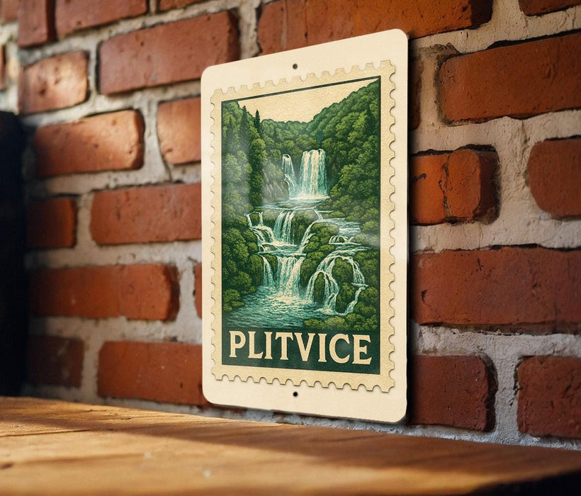 A framed image of a waterfall is hanging on a brick wall.