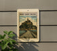 A vintage-style postage stamp depicting the Mont Saint-Michel, a famous landmark in France, is displayed on a wall.