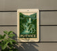 A framed image of a waterfall is mounted on a wall, with the word "PLITVICE" written below it.
